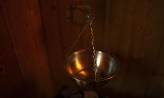 A hanging metal bowl in a calm environment. The lighting creates a relaxing atmosphere.
