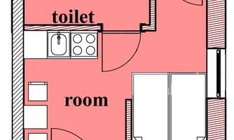An overview of a room plan with a bathroom and a toilet area. The rest of the room includes a kitchen and two beds.