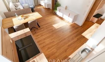 A modern living room with an open kitchen and a dining table. The sun-drenched space has wooden flooring and minimalist furniture.