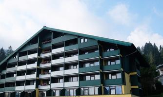 A large building with a distinctive roof and balcony. At the lower section, the word "RESTAURANT" is displayed.
