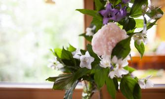 A beautiful bouquet of various flowers in a glass. The colors are vibrant and the atmosphere is fresh and inviting.