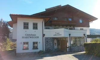 A cozy guesthouse with traditional wood and stone elements. The entrance is invitingly designed and encourages visitors to linger.