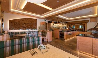 An elegant restaurant with wooden-paneled interiors and cozy seating areas. The lighting creates an inviting atmosphere.