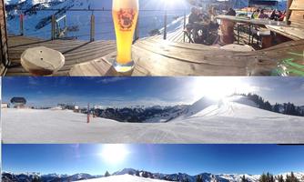 A sunny mountain landscape with snow-covered peaks and a vast blue sky. In the foreground, there is a glass of beer on a wooden terrace.
