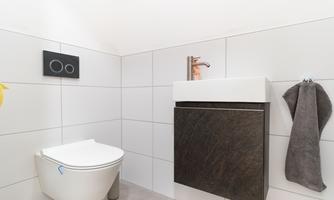 A modern toilet with an elegant sink.