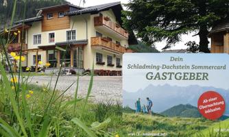 A cozy guesthouse in the mountains with flowers in the foreground. The sign indicates that it is a host for the Schladming-Dachstein Sommercard.