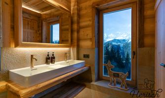 A modern bathroom with wooden elements and large windows. The view overlooks a magnificent mountain landscape.