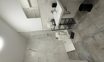 A modern bathroom with a shower and a sink. The walls are decorated with light tiles, and there is a mirror above the sink.