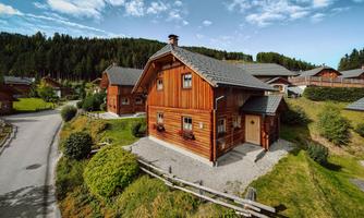 A cozy wooden house in a picturesque setting.  
Surrounded by green meadows and forests, perfect for a quiet retreat.