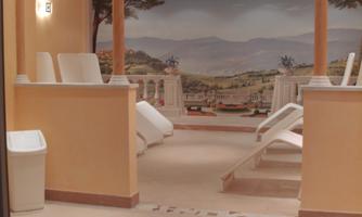 A relaxing wellness area with loungers and soft colors. A picturesque mural creates a soothing atmosphere.