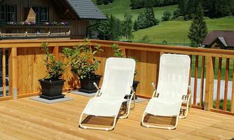 A sunny terrace with two white loungers and potted plants. In the background, green meadows and trees can be seen.