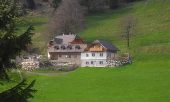 A picturesque house in a green landscape. Surrounded by trees and meadow, it exudes rural charm.