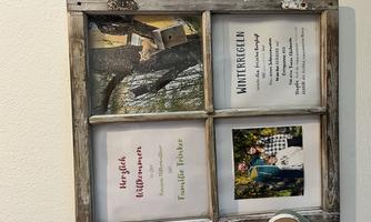 A decorative picture frame with a welcome sign and family photo. Also includes winter rules for guests.