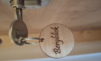 A wooden plaque with the inscription "Mountain View" hangs on a key. The key is inserted in a metal door lock.