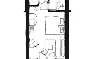 A floor plan drawing of a suite with various rooms. The layout shows sleeping and living areas as well as a bathroom.