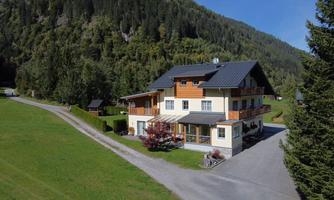 A spacious house amidst green meadows and trees. The surroundings are quiet and idyllic, perfect for relaxation.