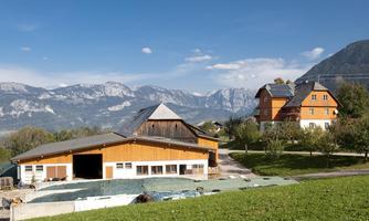 A picturesque view of rural buildings with mountains in the background. The scene showcases a harmonious blend of nature and architecture.