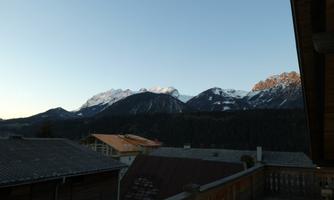 A beautiful view of the majestic mountains with snow. The twilight bathes the landscape in soft colors.