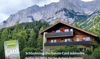 A picturesque mountain house surrounded by green forests and majestic mountains. The Schladming-Dachstein Card is valid for visits from mid-May to early November.