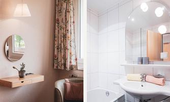 A cozy room with a round mirror, a plant on a table, and a comfortable armchair. On the other side is a modern bathroom with a white bathtub and a mirror above the sink.