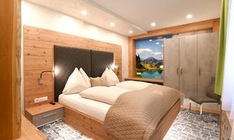A modern bedroom with wooden walls and a large window showing a landscape with mountains. The room is comfortably furnished with a double bed and a wardrobe.