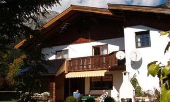 A charming multi-family house in alpine style. The garden is green and inviting, ideal for relaxed hours outdoors.