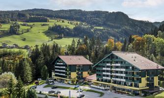 A modern accommodation amidst green hills and trees. The surroundings are quiet and inviting.