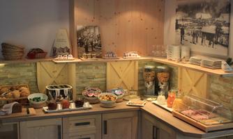 An inviting buffet with various dishes and drinks. Wooden shelves and cozy lighting create a warm atmosphere.