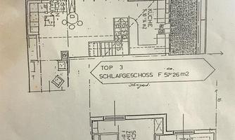 A construction drawing of a living space with two floors. The plan shows the layout of rooms such as kitchen, living room, and bedroom.