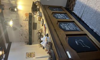 A cozy reception desk made of wood with chalkboards and decorative elements. The warm colors and soft lighting create an inviting atmosphere.