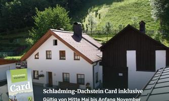 An attractive accommodation in the mountains with a green landscape in the background. In the foreground is a map that points to various offers.