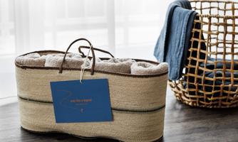 A stylish basket made of woven material with towels in it. Next to it stands another basket with blue towels.
