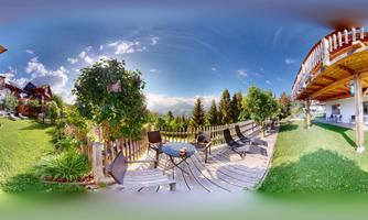 A beautiful outdoor area with a wooden terrace and chairs. In the background, there are mountains and a clear sky.