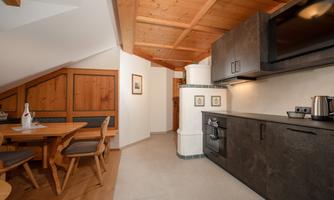A cozy kitchen with wood paneling and modern appliances. The dining area is bright and invitingly designed.