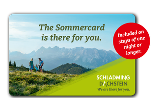 An impressive mountain panorama with people hiking in the foreground. The focus is on the summer map of Schladming-Dachstein, which offers advantages for stays.