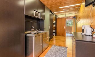 A modern kitchen with elegant wood and metal elements. Bright and open, ideal for meal preparation.