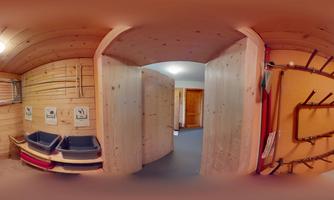 A friendly wooden room with hanging options and storage for sports equipment. The walls are light and the room feels inviting and well-organized.