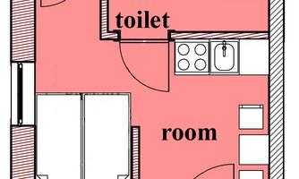 A floor plan of a room with a bathroom and toilet. The layout shows furniture and kitchen area.