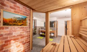 A modern sauna with wood and salt walls. The room is bright and inviting, perfect for relaxing.