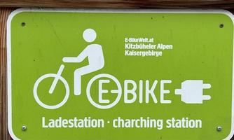 A sign for an E-bike charging station. It displays an icon of a cyclist and the word "E-BIKE".