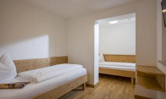 Bedroom with two single beds and TV.