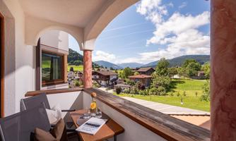 A balcony with a beautiful view of the surrounding mountains.