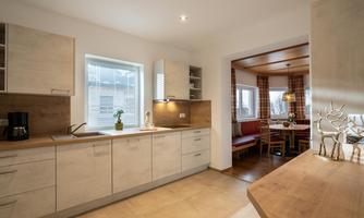 Large, fully equipped kitchen with open dining area.