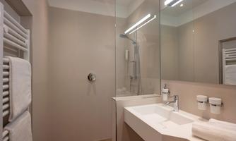 A modern bathroom with a shower and a sink.