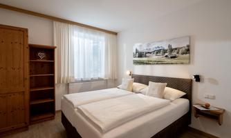 Bedroom with a double bed and two single beds.
