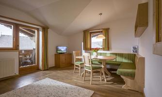 Cozy living area with a dining corner and a television.