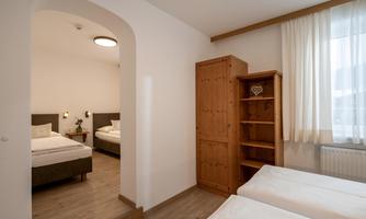 Bedroom with a double bed and two single beds.