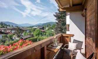 A balcony with a view of the mountains and the surrounding landscape.