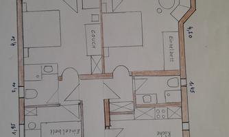 A floor plan of an apartment with several rooms. It shows the arrangement of bedroom, living room, and bathroom.