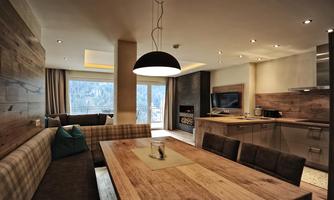 A modern apartment with an open kitchen and a large dining area.  
Large windows provide plenty of light and offer a view of nature.